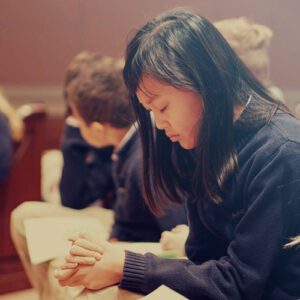 Pg 18 About Us-Faith Commitment-Student Praying Pg 18 About Us-Faith Commitment-Student Praying